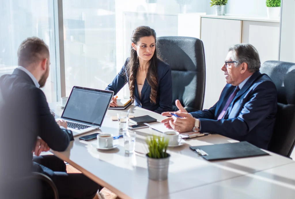 Nonprofit executive talking with wealth advisors in office