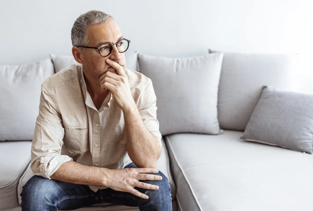 Man sitting on the couch thinking
