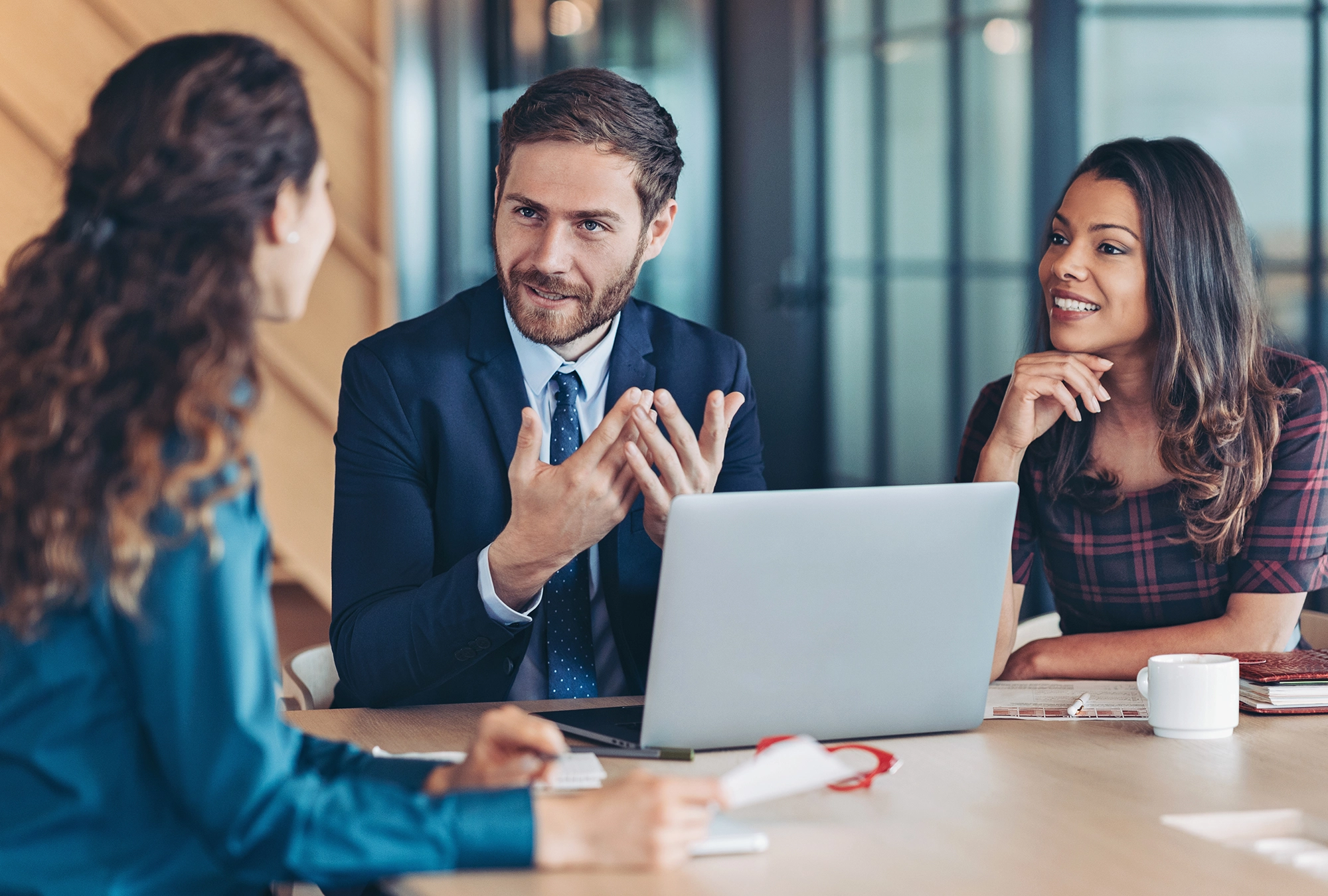 woman talking with retirement advisors in office