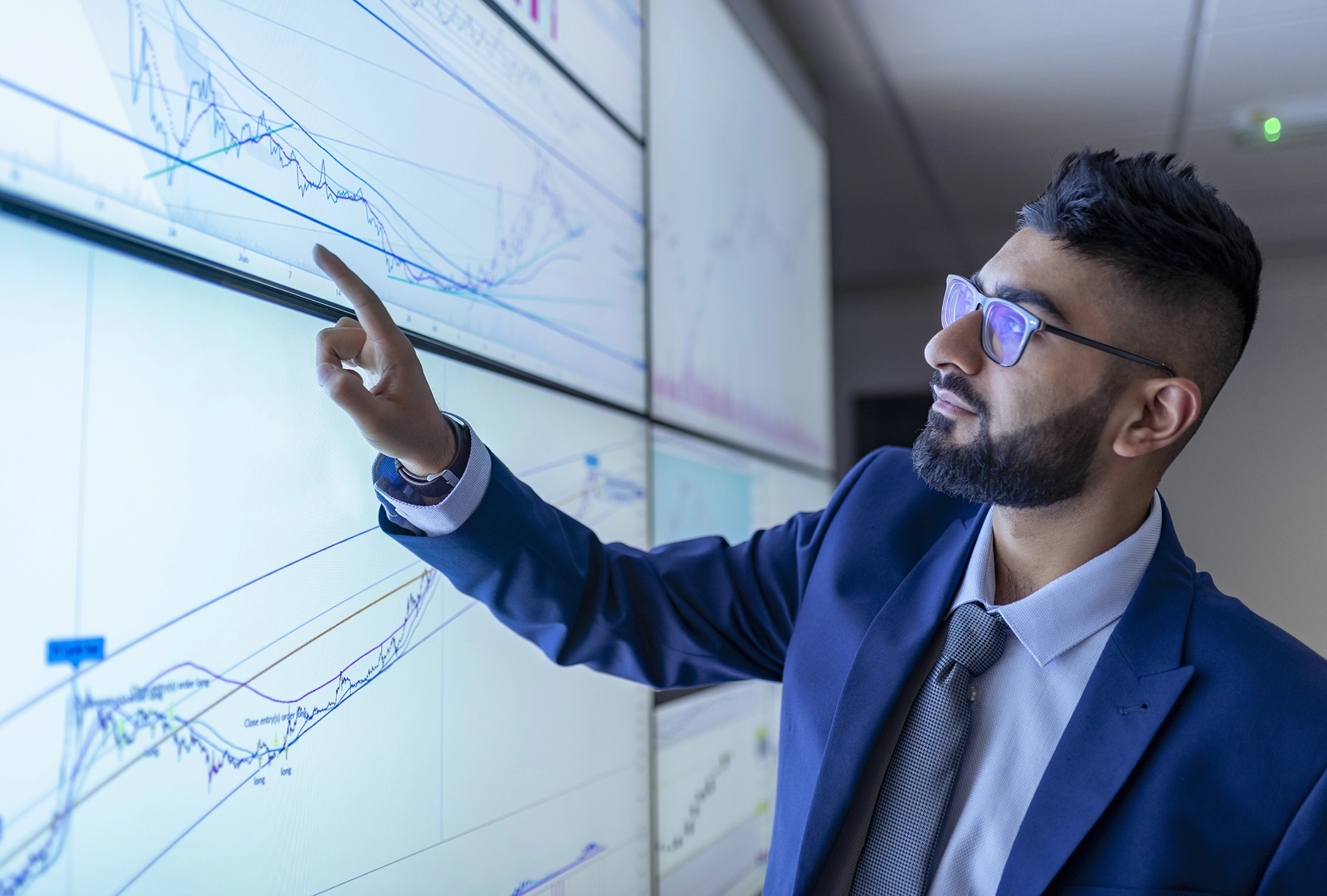 a financial advisor analyzing market trends on big screen