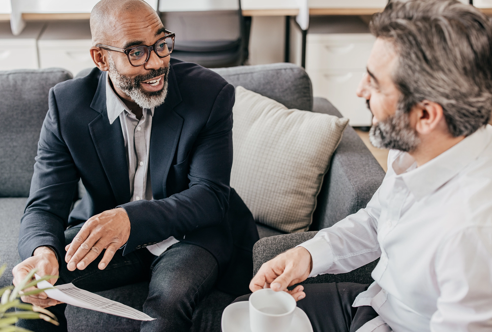 man sitting and talking with a financial advisor