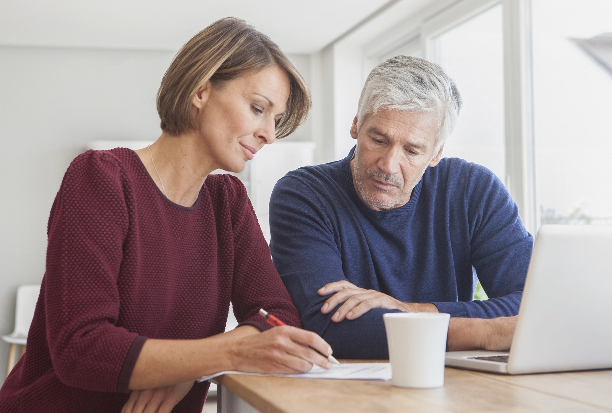 husband and wife looking at their Roth IRA documents