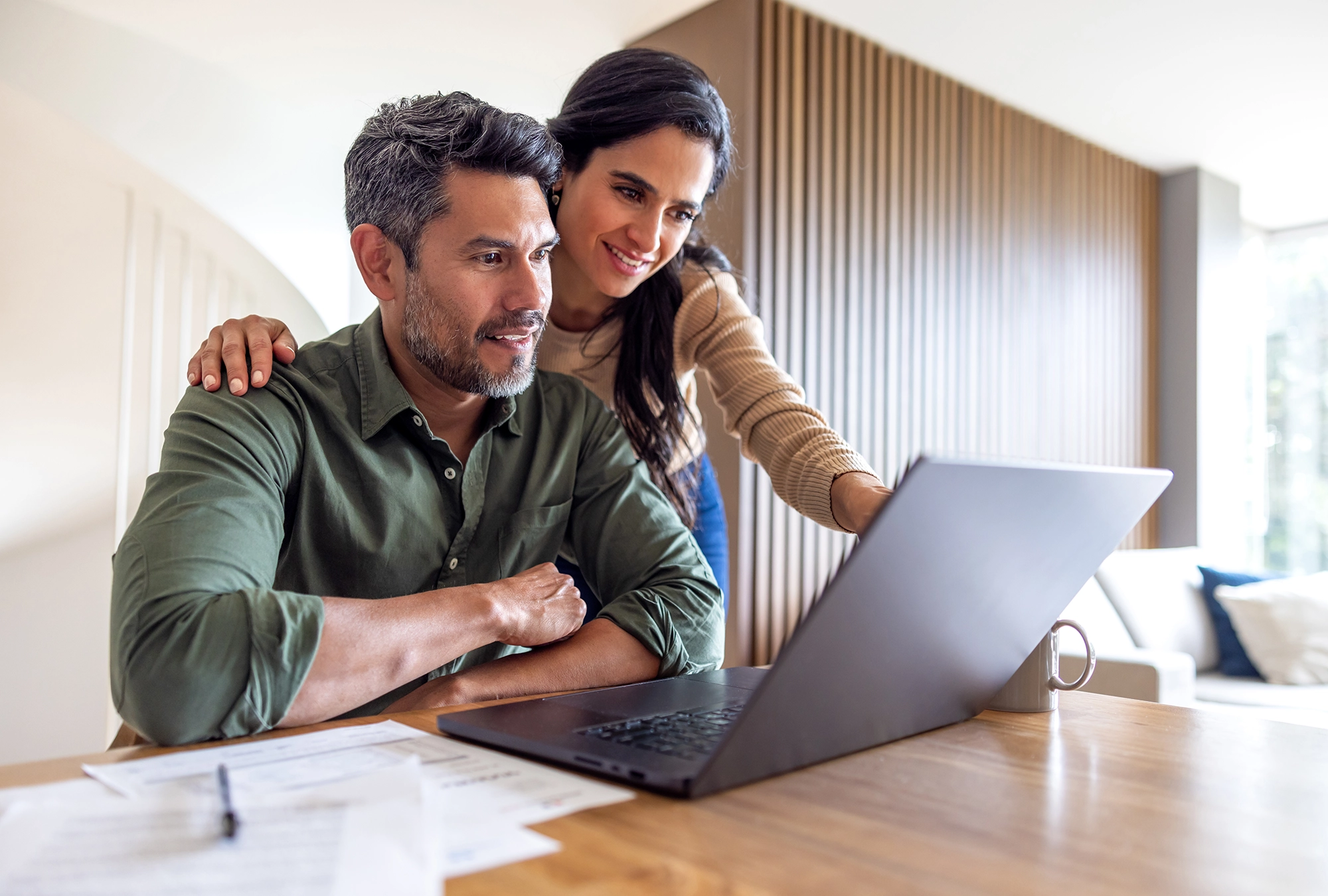 married couple looking at retirement information on computer