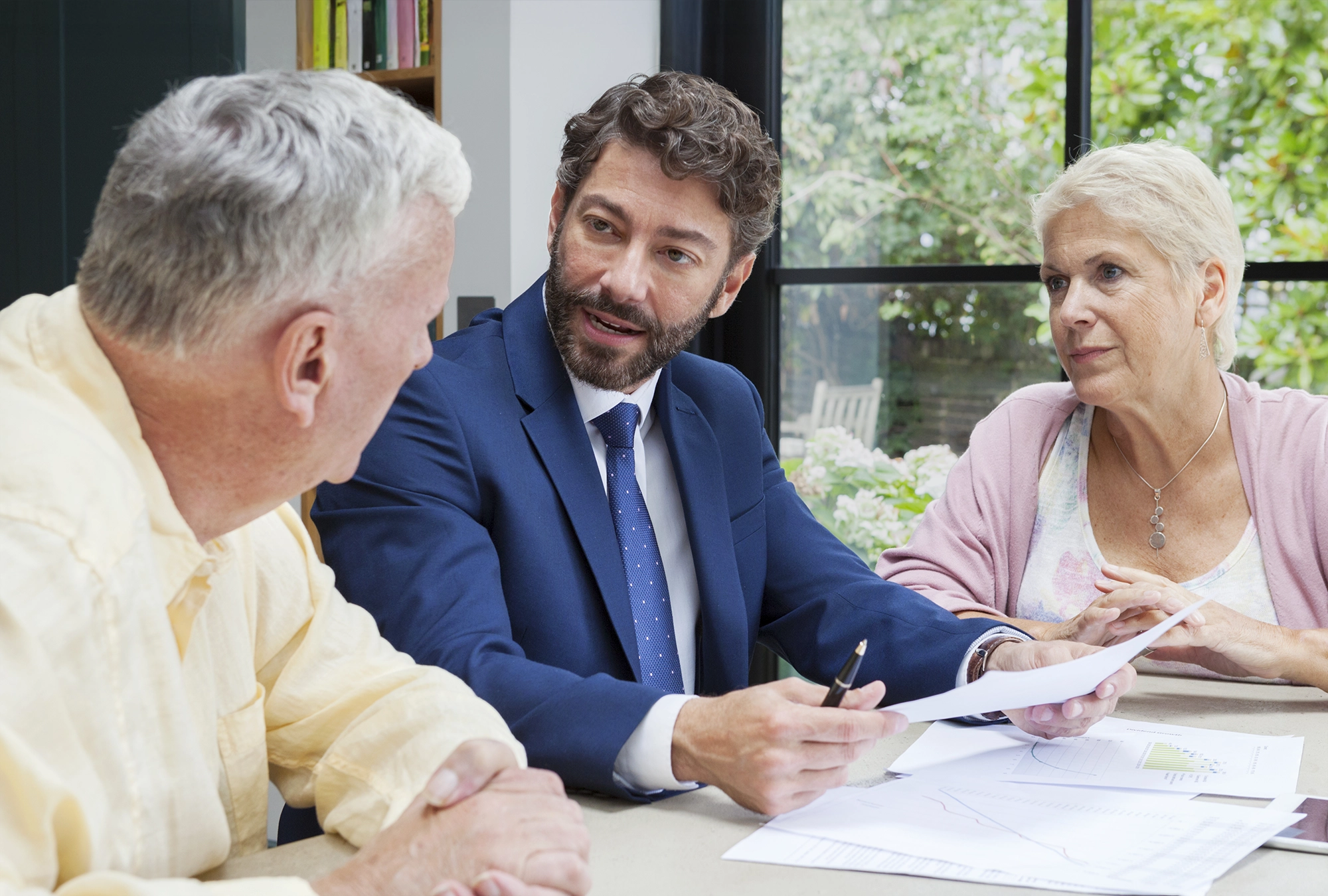older couple sitting down, talking with an estate planner