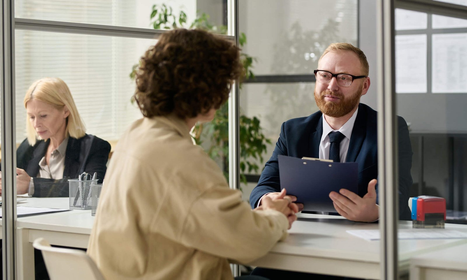 Federal employee helping someone at his desk