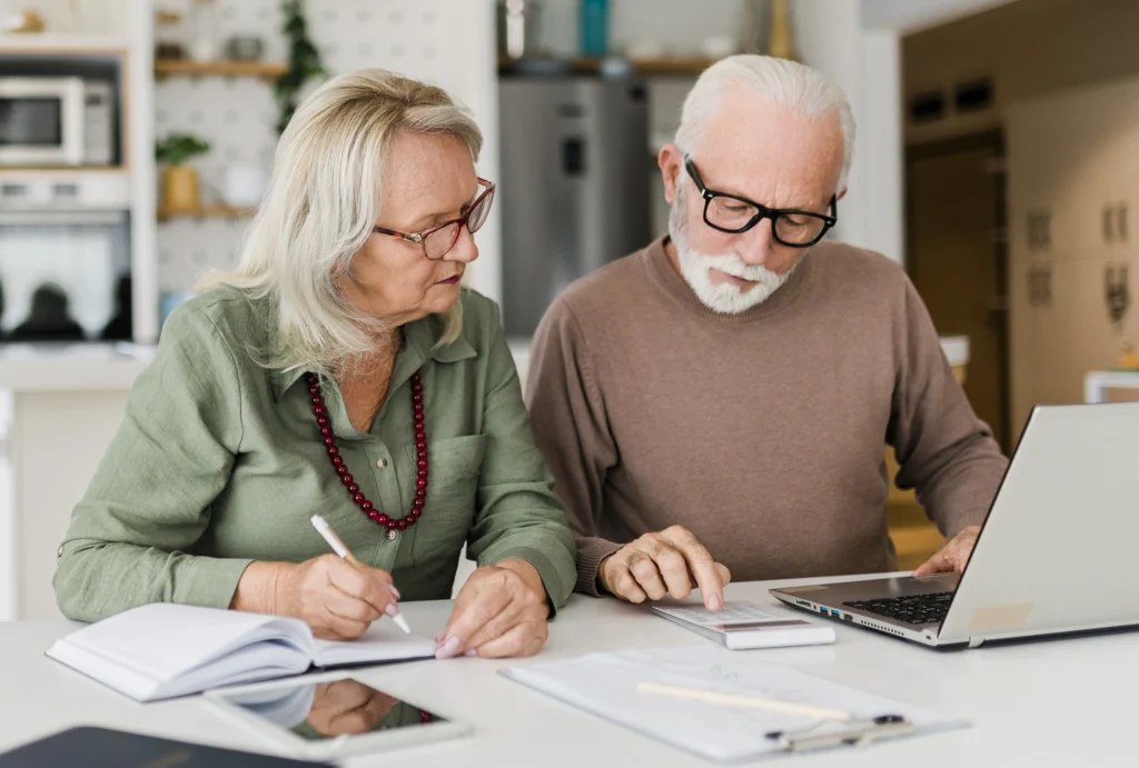 husband and wife calculating taxes at a table