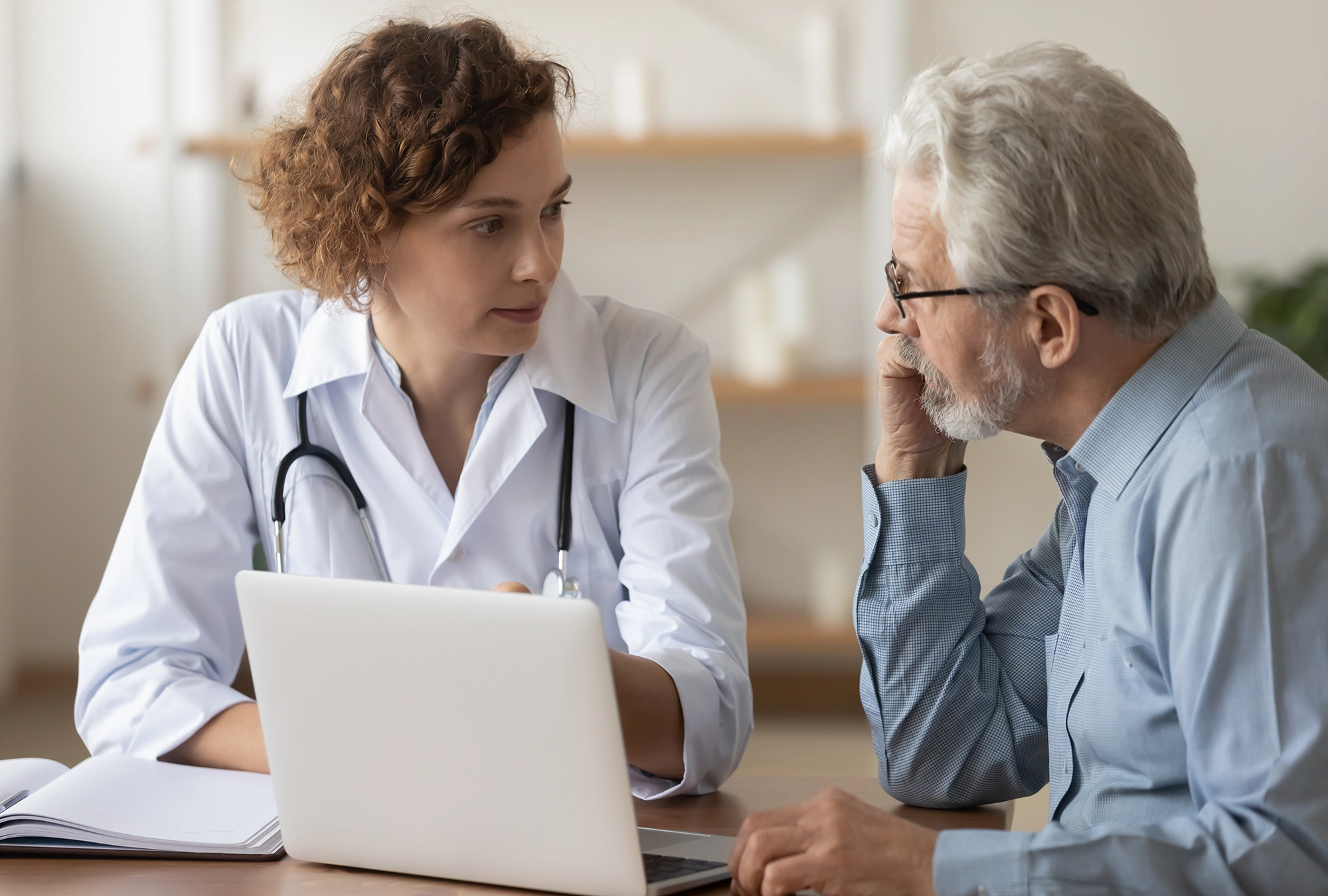 Doctor delivering bad news to an older gentleman